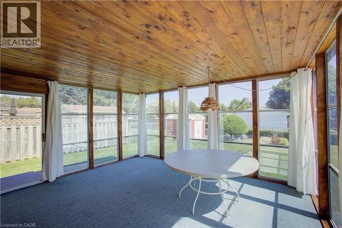 Sunroom with wood-paneled ceiling, wall-to-wall carpeting, and sliding glass door access to the exterior - 52 Queenston Crescent, Kitchener, ON -  Photo Showing Other Room