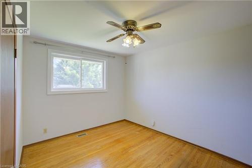 Hardwood flooring, white walls, white window trim, and a ceiling fan with integrated lighting - 52 Queenston Crescent, Kitchener, ON - Indoor Photo Showing Bedroom