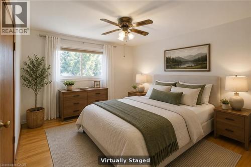Hardwood flooring with a ceiling fan light fixture - 52 Queenston Crescent, Kitchener, ON - Indoor Photo Showing Other Room