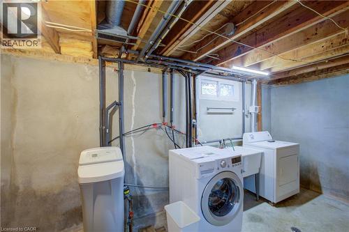 Utility room featuring exposed ceiling joists, a small window, and a utility sink - 52 Queenston Crescent, Kitchener, ON - Indoor Photo Showing Laundry Room