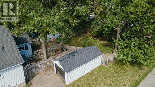 Detached garage, tiered wood decking, partial wood fence, partial picket fence, mature trees - 99 Shantz Lane, Kitchener, ON - Outdoor
