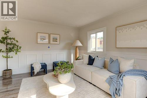 Warm neutral wall tones with decorative wainscoting and crown molding - 99 Shantz Lane, Kitchener, ON - Indoor Photo Showing Living Room