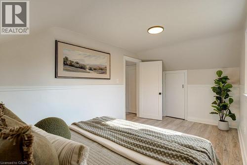 Sloped ceilings, wood-finish flooring, accent wainscoting, and recessed lighting - 99 Shantz Lane, Kitchener, ON - Indoor Photo Showing Bedroom