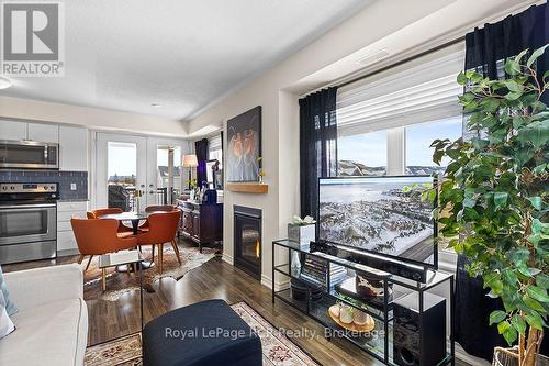 Staged Photo - Living and Dining - #308 - 7 Anchorage Crescent, Collingwood, ON - Indoor With Fireplace