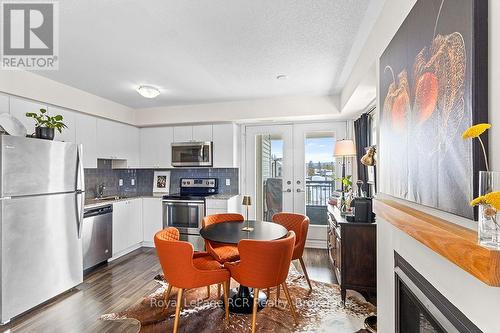Staged Photo - Dining and Kitchen - #308 - 7 Anchorage Crescent, Collingwood, ON - Indoor Photo Showing Kitchen With Stainless Steel Kitchen