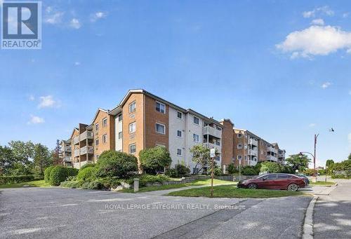 404 - 345 Centrum Boulevard, Ottawa, ON - Outdoor With Balcony With Facade