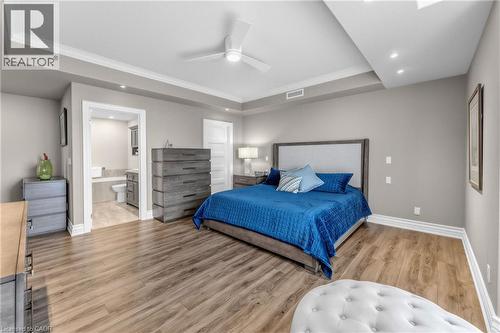 Wood-finish flooring, recessed lighting, ceiling fan, crown molding, and an attached ensuite bathroom - 1477 Lakeshore Road Unit# Ph 1, Burlington, ON 