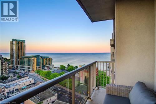 Balcony with glass and metal railings, overlooking a body of water and urban landscape - 1477 Lakeshore Road Unit# Ph 1, Burlington, ON 