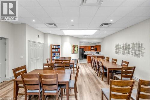 Recessed lighting, wood-finish flooring, white walls, and a full kitchen with dark appliances - 1477 Lakeshore Road Unit# Ph 1, Burlington, ON 
