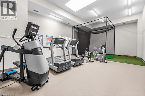 Dedicated fitness area featuring a golf simulator, exercise equipment, and overhead lighting - 1477 Lakeshore Road Unit# Ph 1, Burlington, ON 