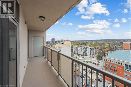 Balcony featuring a glass panel railing, concrete flooring, and an exterior light fixture - 1477 Lakeshore Road Unit# Ph 1, Burlington, ON 