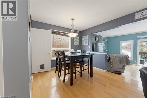 Hardwood flooring throughout, recessed ceiling with pendant lighting, and a white interior door - 592 Little Dover Crescent, Waterloo, ON - Indoor Photo Showing Dining Room
