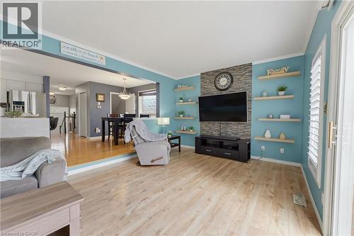 Recessed entertainment wall with stone-finish accent and integrated shelving - 592 Little Dover Crescent, Waterloo, ON - Indoor Photo Showing Living Room