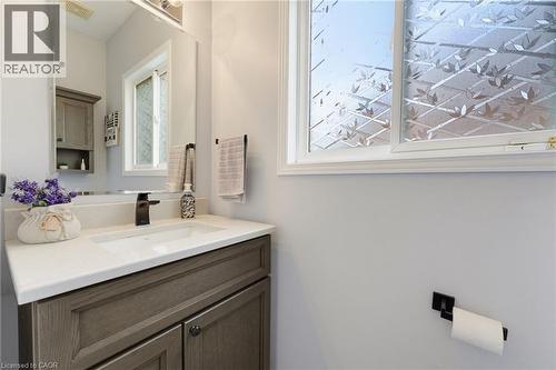 White single-basin sink with a dark bronze faucet, set into a light-toned countertop - 592 Little Dover Crescent, Waterloo, ON - Indoor Photo Showing Bathroom