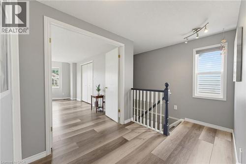 Wood-finish flooring throughout, framed doorways, and a track lighting fixture - 592 Little Dover Crescent, Waterloo, ON - Indoor Photo Showing Other Room