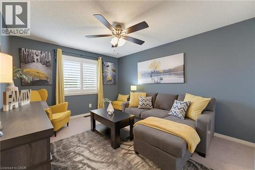Recessed lighting, ceiling fan, window with plantation shutters, light-toned carpeting, and painted walls - 592 Little Dover Crescent, Waterloo, ON - Indoor Photo Showing Living Room