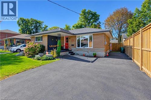 Brick exterior with a gabled roof and white-framed windows - 87 Bond Street, Kitchener, ON 