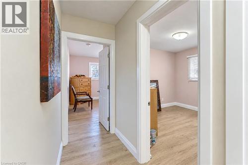 Light-toned walls with wood-finish flooring throughout - 87 Bond Street, Kitchener, ON 