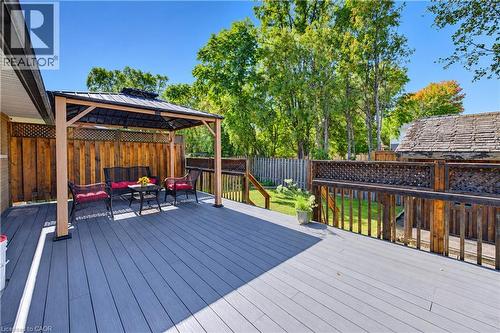 Expansive deck featuring composite decking, a built-in gazebo, and a patterned wood railing - 87 Bond Street, Kitchener, ON 