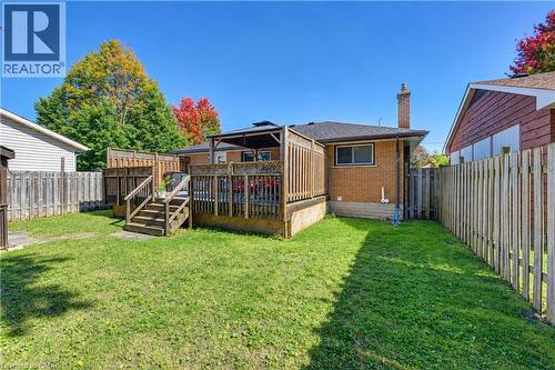 Expansive backyard featuring a multi-level wood deck, a covered gazebo, and a brick exterior - 87 Bond Street, Kitchener, ON 
