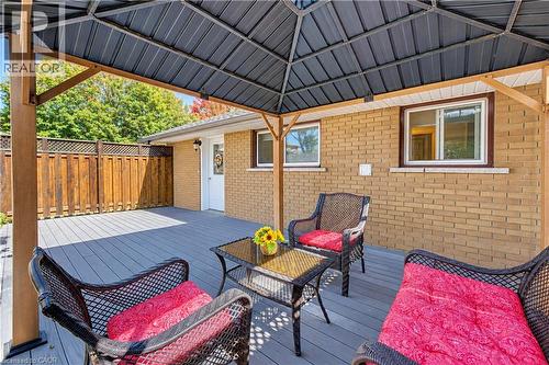 Covered outdoor patio with composite decking, a permanent metal gazebo, and a full privacy fence - 87 Bond Street, Kitchener, ON 