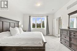 Primary Bedroom with Large Window to Backyard - 