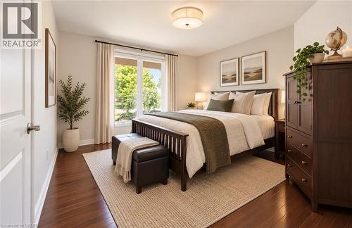 Hardwood flooring, neutral wall tones, a large window with white trim, and a semi-flush mount ceiling light fixture - 56 Windrush Trail, Kitchener, ON 