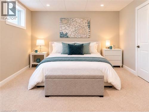 Recessed lighting, light beige carpeting, white trim, and a window - 56 Windrush Trail, Kitchener, ON 