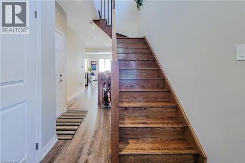 Wood-finish flooring throughout the hallway - 65 Waterview Lane, Grimsby, ON 