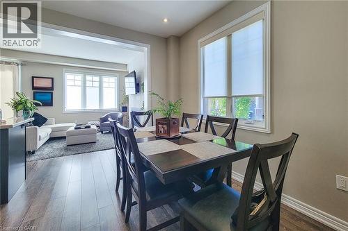 Wood-finish flooring throughout, recessed lighting, and a broad cased opening - 65 Waterview Lane, Grimsby, ON 