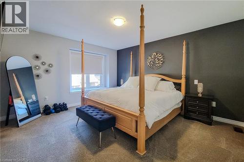 Window with roller shade, carpeted flooring, and neutral wall tones - 65 Waterview Lane, Grimsby, ON 