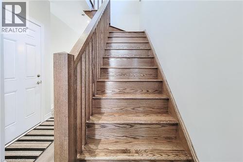 Hardwood staircase with natural wood-finish treads and balusters - 65 Waterview Lane, Grimsby, ON 