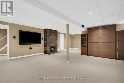 Lower level living area with gas fireplace. - 24 Tammela Court, Ottawa, ON 
