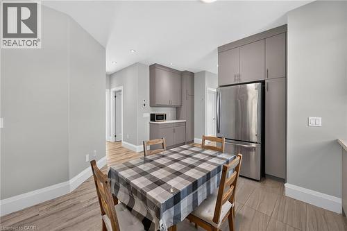 Recessed lighting, wood-finish flooring, stainless steel refrigerator, and built-in cabinetry - 41 Eleanor Avenue, Hamilton, ON 