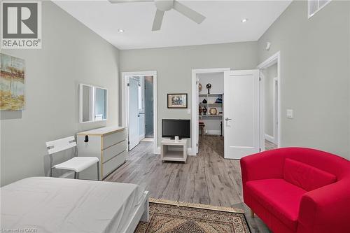 Light gray wall paint, wood-finish flooring, recessed ceiling lights, white ceiling fan, and white doors - 41 Eleanor Avenue, Hamilton, ON 