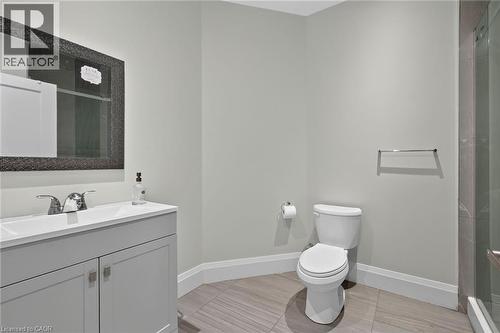 Vanity with a white sink, chrome faucet, and gray cabinetry - 41 Eleanor Avenue, Hamilton, ON 