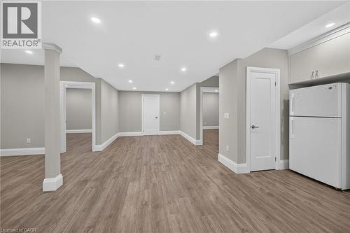 Spacious room with wood-finish flooring, recessed lighting, neutral wall tones, and white trim - 41 Eleanor Avenue, Hamilton, ON 
