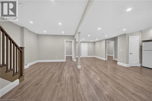Spacious room featuring recessed lighting, wood-finish flooring, white trim, and multiple doorways - 41 Eleanor Avenue, Hamilton, ON 
