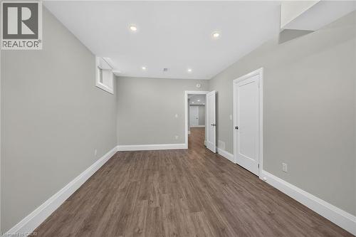 Recessed lighting, wood-finish flooring, white trim, and a white interior door - 41 Eleanor Avenue, Hamilton, ON 