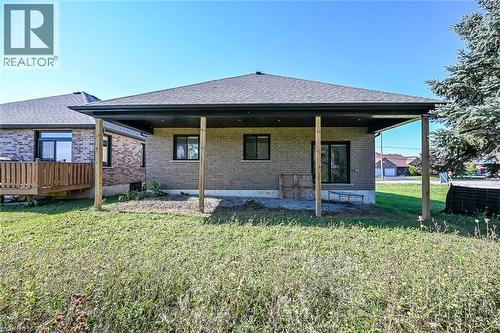Brick exterior with a covered patio area and a visible wood deck - 41 Eleanor Avenue, Hamilton, ON 