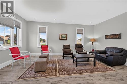 Recessed ceiling lighting, light gray wall paint, wood-finish flooring, white window trim, and neutral window treatments - 41 Eleanor Avenue, Hamilton, ON 