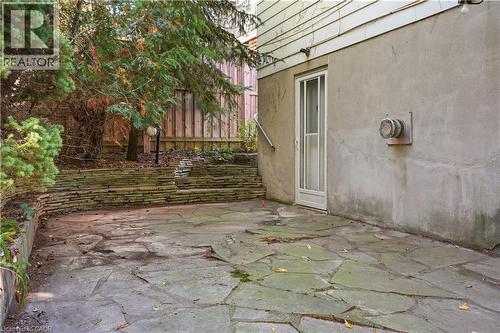 Flagstone patio with a stacked stone retaining wall - 12 Hill Street, Kitchener, ON 