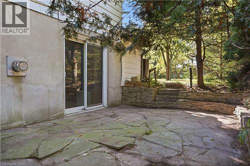 Flagstone patio with a stacked stone retaining wall - 12 Hill Street, Kitchener, ON 