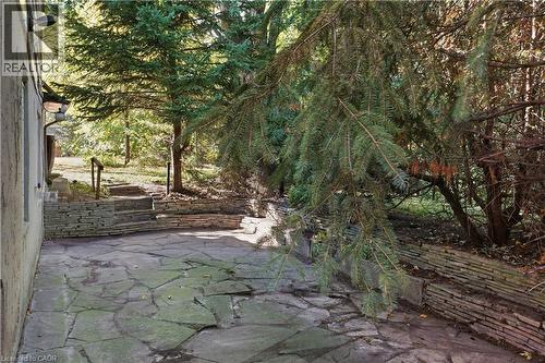 Flagstone patio with a stacked stone retaining wall - 12 Hill Street, Kitchener, ON 