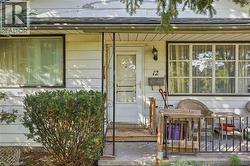 White horizontal siding exterior with a front entry door and a decorative screen door - 