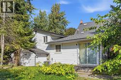 Sliding glass door access, exterior deck, multiple skylights, and a chimney feature - 