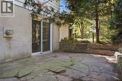 Flagstone patio with a stacked stone retaining wall - 