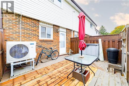 Rear patio featuring wood decking and enclosed wood privacy fencing - 227 Fergus Avenue, Kitchener, ON 