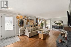 Hardwood flooring throughout, a decorative glass entry door, and a stone-clad fireplace - 