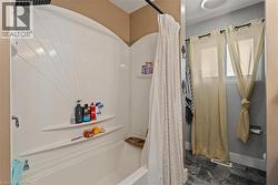 Tub and shower combination with integrated shelving - 